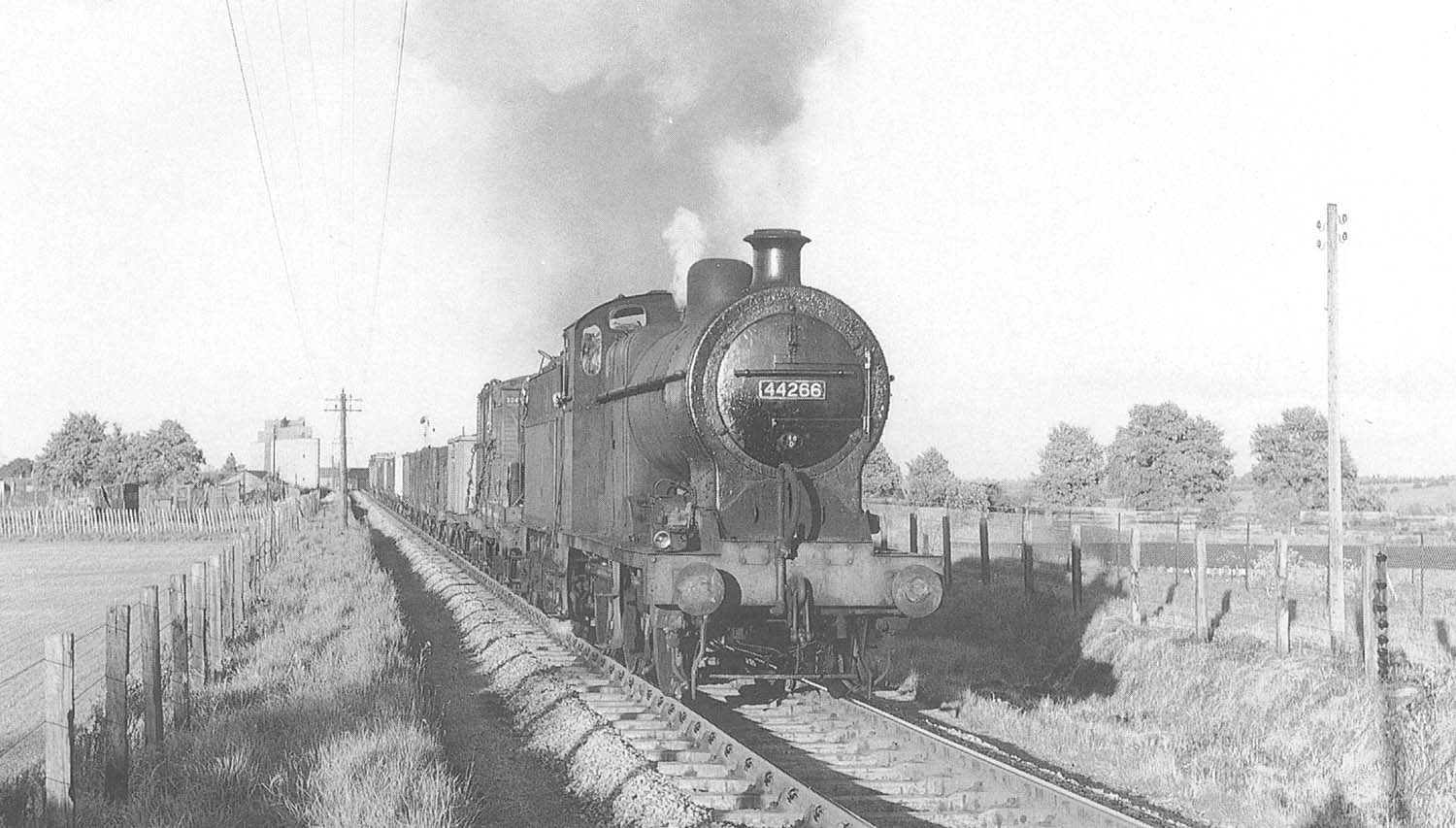 Ex-LMS 4F 0-6-0 No 44266 leaves Stratford for Broom with a Class 8 through mineral or empty wagon train