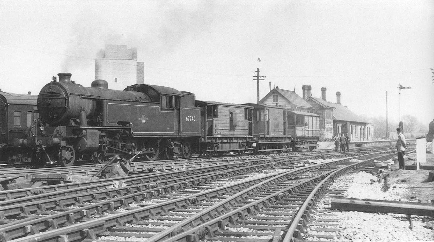 British Railways built L1 2-6-4T No 67740 with three brake vans in tow pauses at Stratford Old Town on 25th April 1960