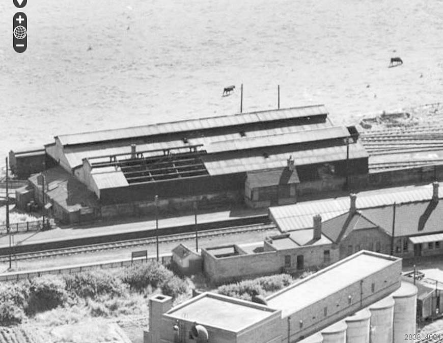 An aerial view of Stratford Old Town's locomotive shed showing the section of roof without its corrugated sheeting on 23rd June 1952