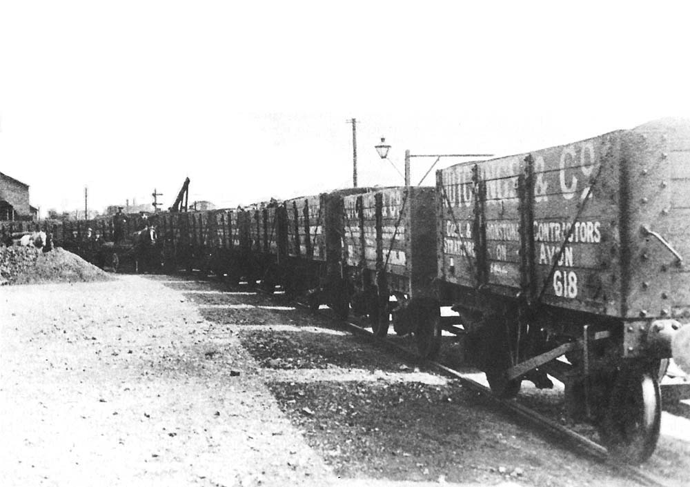 A line of Hutchings & Company's Private Owned six-plank open mineral wagons runs into the goods shed circa 1900