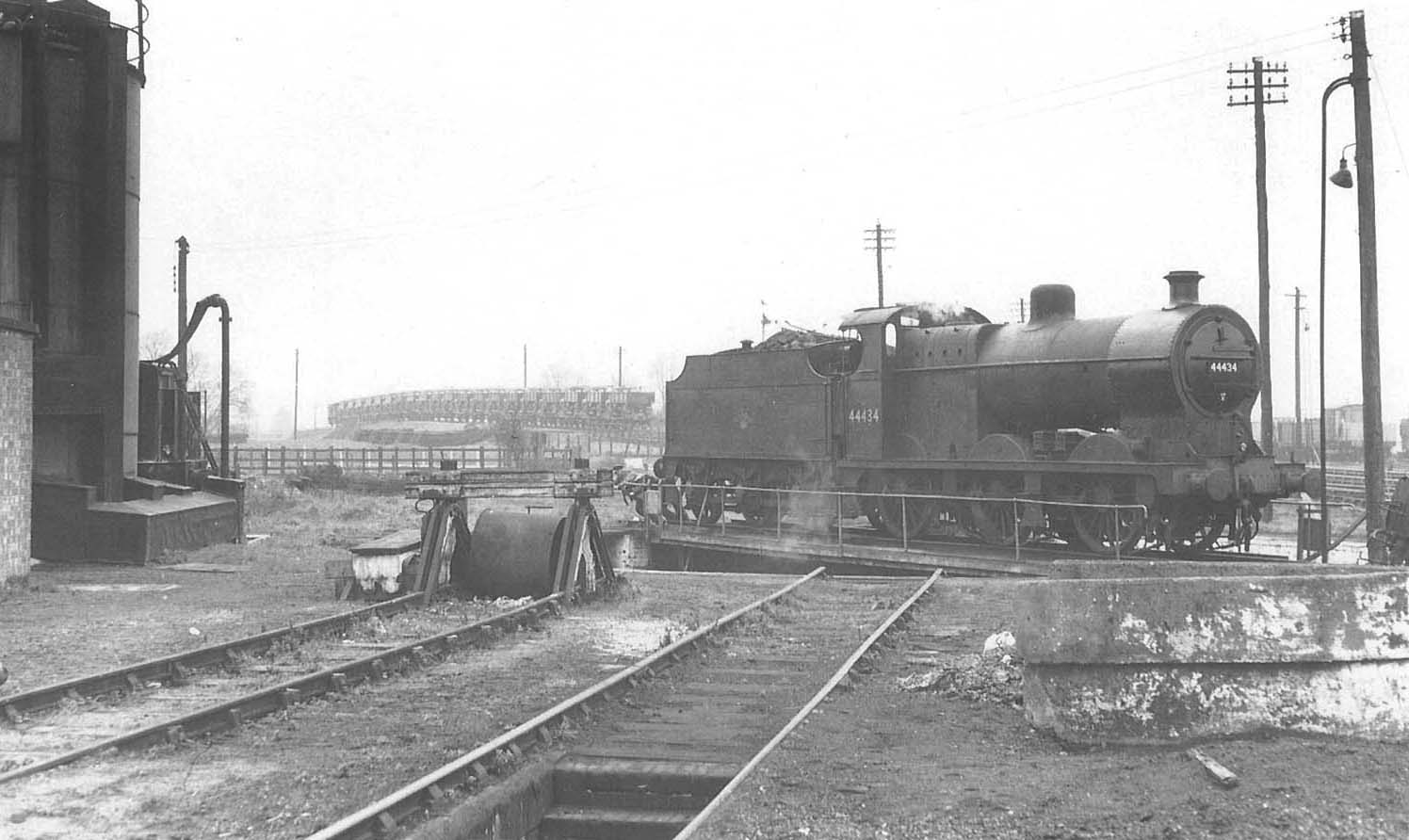 Ex-LMS 4F 0-6-0 No 44434 is proving to be very hard work for driver and fireman turning it by hand on 8th April 1958