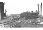 Ex-LMS 4F 0-6-0 No 44434 is proving to be very hard work for driver and fireman turning it by hand on 8th April 1958