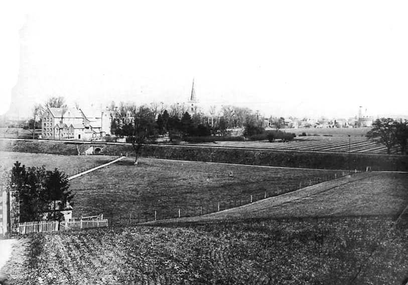 An old photograph showing the railway crossing the River Avon with Lucy's Mill in the background, on the left