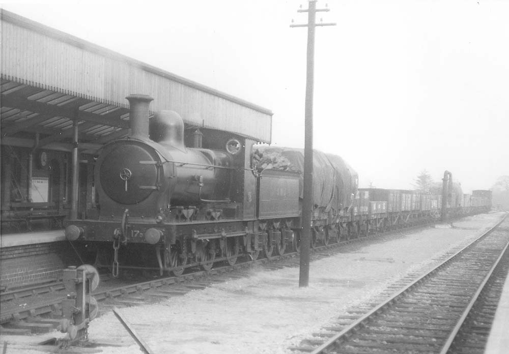 Ex-E&WJR 0-6-0 No 17 is seen on 11th April 1924 bringing a goods train through the station 'wrong road'