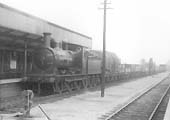 Ex-E&WJR 0-6-0 No 17 is seen on 11th April 1924 bringing a goods train through the station 'wrong road'