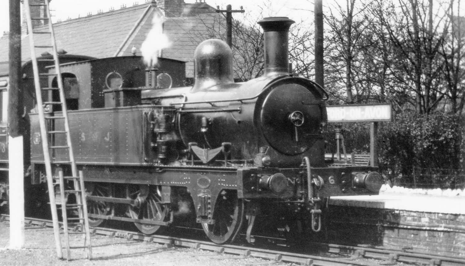 Ex-E&WJR 2-4-0T No 6, resplendent in its SMJ livery, stands gleaming in the sun at the head of a Towcester train circa 1909-10