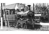 Ex-E&WJR 2-4-0T No 6, resplendent in its SMJ livery, stands gleaming in the sun at the head of a Towcester train circa 1909-10