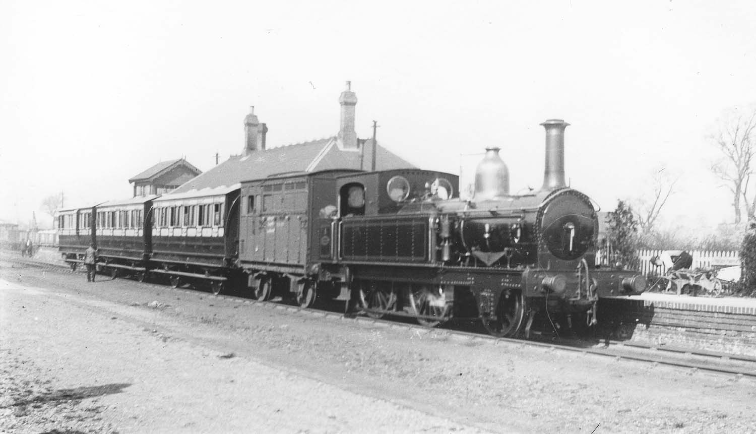 E&WJR 2-4-0T No 1 standing at the head of a three coach local passenger train bound for Towcester