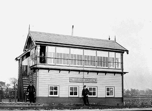 View of Braunston & Willoughby station's signal cabin with staff posing for the camera circa 1910