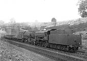 A pair of ex-WD 2-8-0 LNER Class O7s, No 3102 and No 3084, are seen leaving Catesby Tunnel