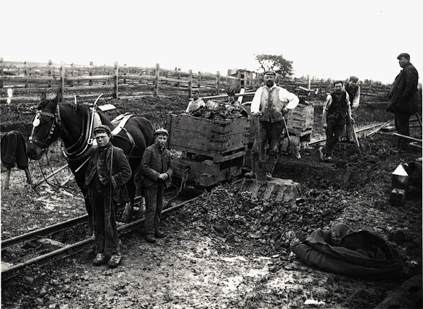 A team of navvies take a short break from their work to pose for Newton's camera