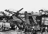 A steam navvy is seen loading spoil on to a contractor's wagon on the site of the new station at Rugby