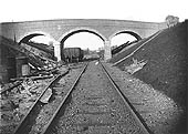 View along a section of temporary trackwork towards a completed brick arch overbridge south of Newton