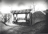 View of the building of a steel girder bridge being erected across a lane one mile south of Newton
