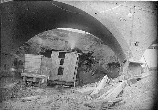 View of a steam shovel being employed beneath the bridge carrying Ashlawn Road over the railway