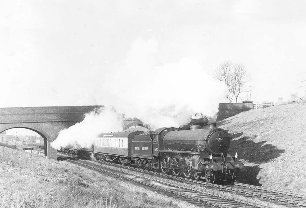 Ex-LNER 4-6-0 B1 61202 is seen passing beneath Catesby Road bridge on a York to Swansea express on 25th April 1950