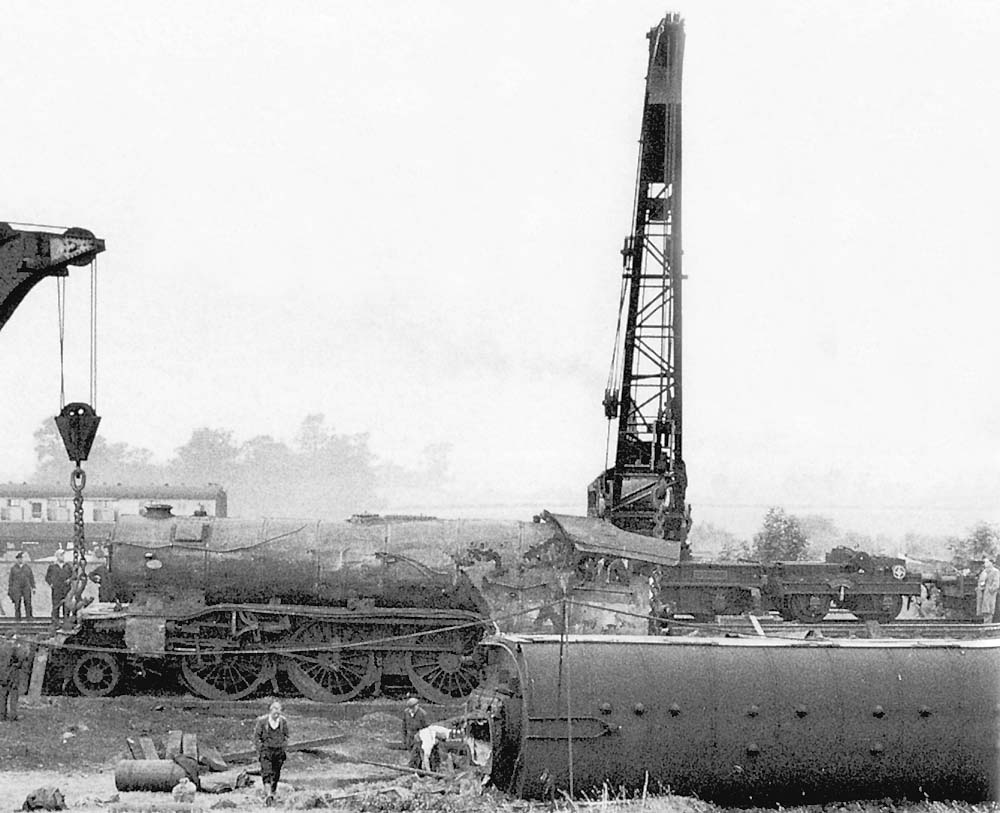 Close up showing the extensive damage caused to the locomotive's running plate, boiler and cab