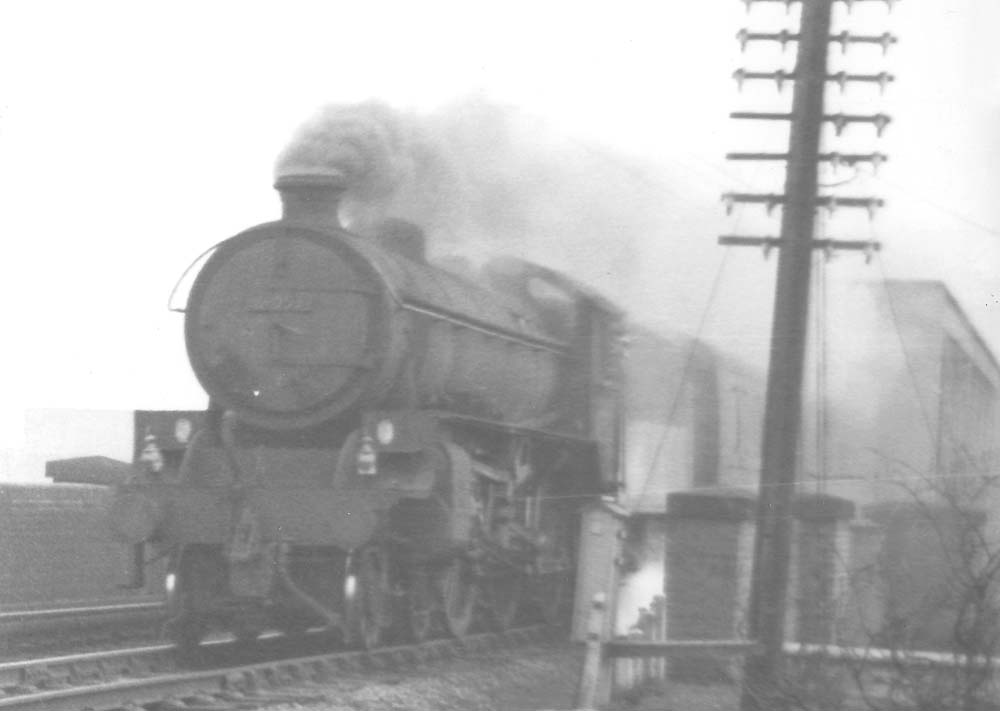 An unidentified ex-LNER Class B1 4-6-0 locomotive is seen working hard as it heads an up express passing over the West Coast main line