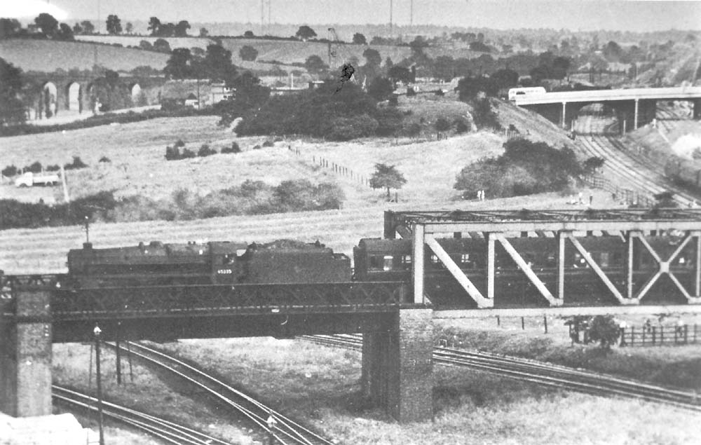 Rugby Central Station ExLMS 5MT 460 No 45335 is seen passing over