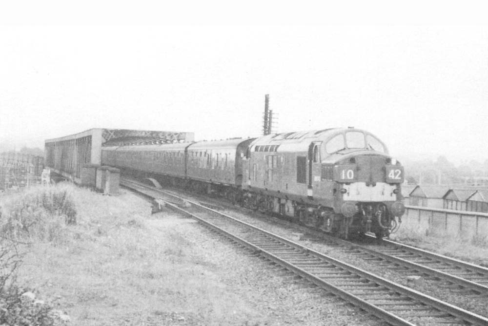 An unidentified British Railways English Electric Type 3 Diesel Electric locomotive is seen crossing the Birdcage bridge