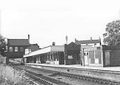 Looking towards Leicester showing the down platform and the booking hall and offices spanning the tracks