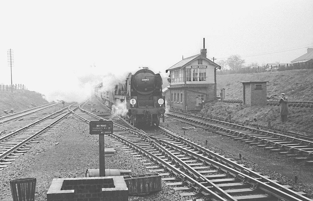 Another view of ex-Southern Railways West Country class 4-6-2 No 34042 'Dorchester' on a football cup special passing Rugby Signal Box in March 1963