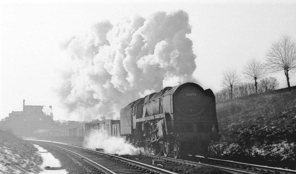 British Railways Standard Class 9F 2-10-0 No 92094 is departing Rugby Central on a Class E express freight service