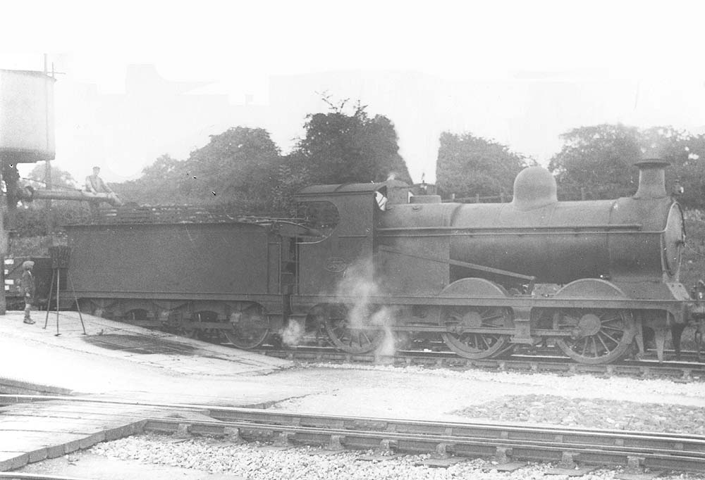 GCR 0-6-0 Class 9J No 233 is seen standing taking on water whilst at the head of an up goods train