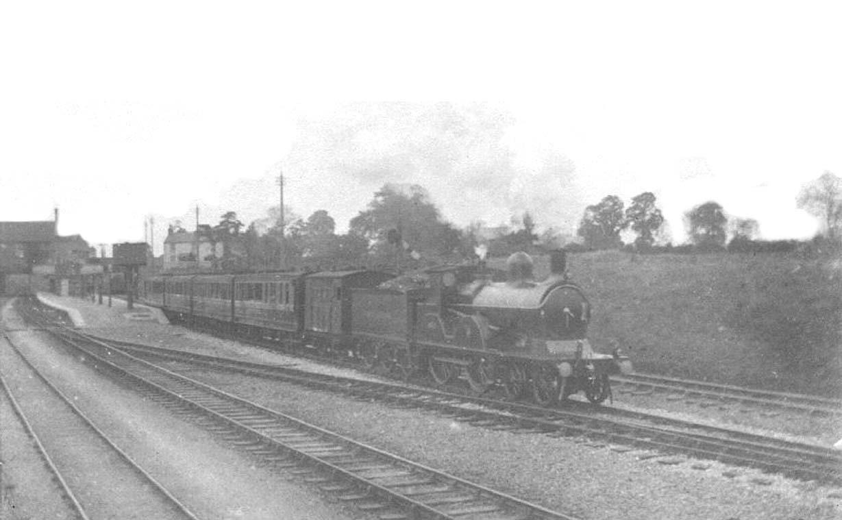 An unidentified GCR 4-4-0 hauls one of the first trains to leave Rugby's GC station when opened in 1899
