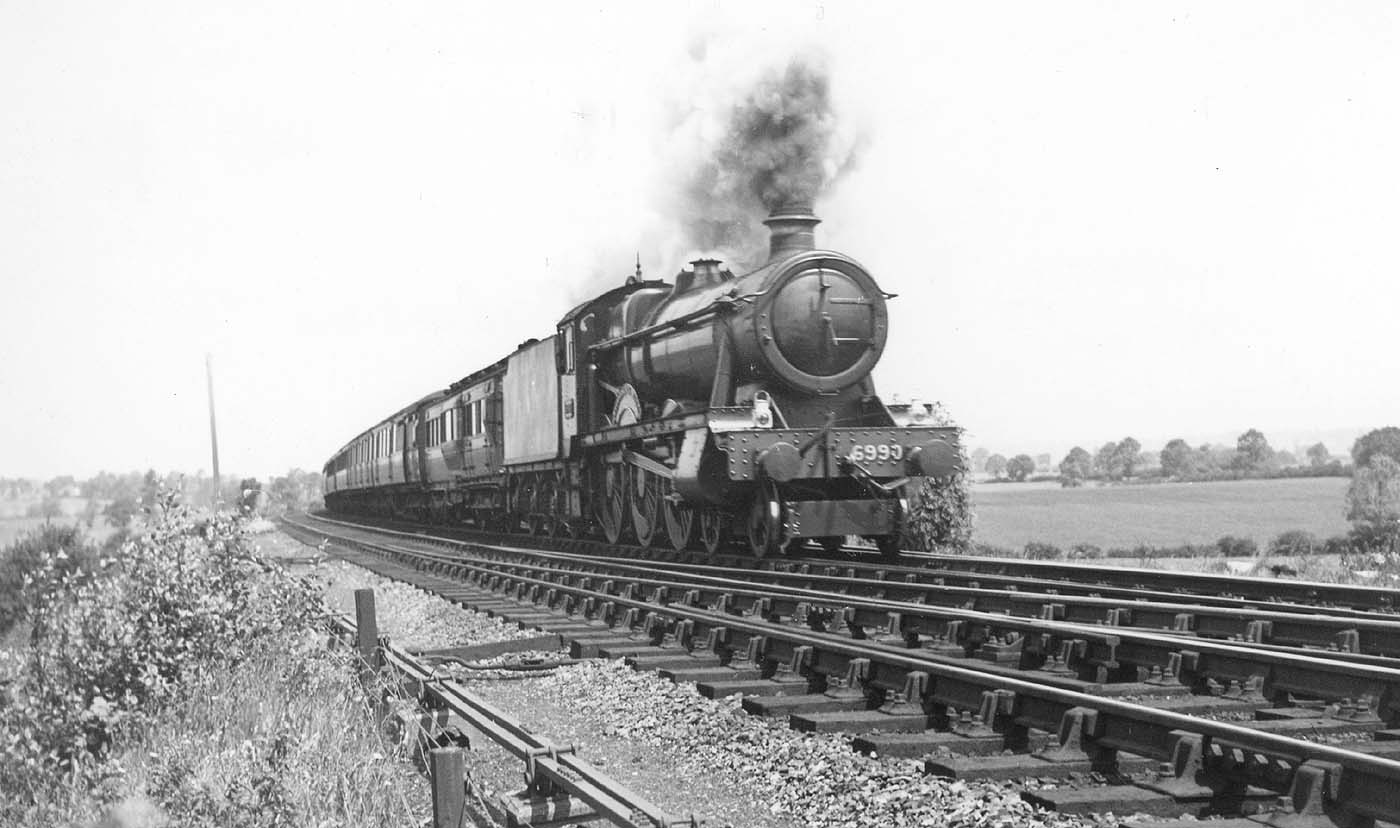 Ex-GWR 4-6-0 Hall Class No 6990 'Witherslack Hall' heads a down express on 30th June 1948 during the locomotive exchanges