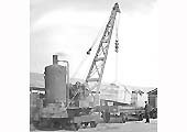 Two crates of �Austin Tractors� being loaded on to a single bolster railway wagon by a steam crane in the early 1920s