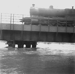 A Great Western Railway 30xx class 2-8-0 locomotive crosses a swollen river Avon during the 1947 floods