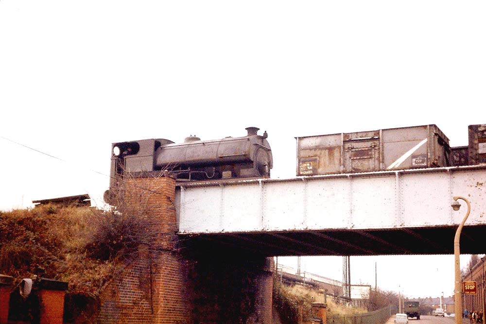 Peckett locomotive 0-4-0ST No 2085 waiting with empty mineral wagons on the Kingfield Road overbridge in December 1970