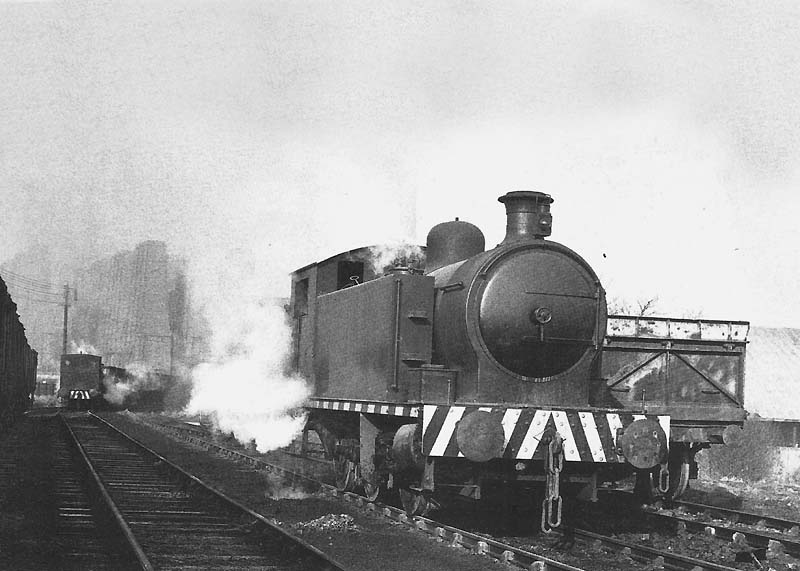 Robert Stephenson & Hawthorn 0-6-0T No 3 waits, while in the background Peckett 'W5' class 0-4-0ST No 1 collects a rake of empty mineral wagons from sidings