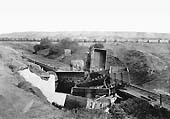 The third of a set of five photos of a rake of derailed loose coupled Newdigate Colliery wagons lying in Coventry Canal