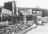 The fifth of a set of five photos of a rake of derailed loose coupled Newdigate Colliery wagons lying in Coventry Canal
