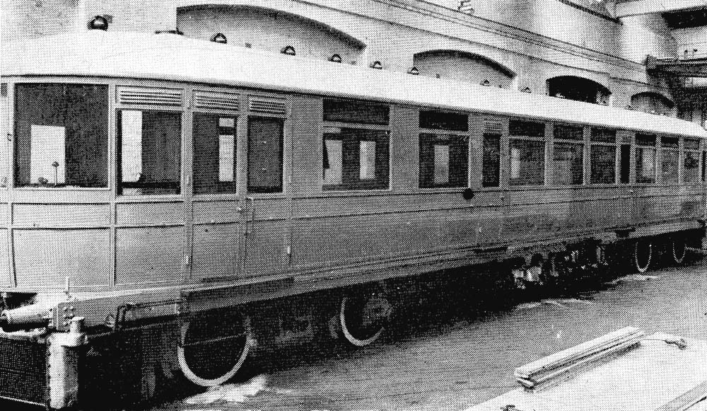 A photograph of the newly painted 1911 Daimler Railcar complete with white painted tyres and filler cap by the side of the buffer beam